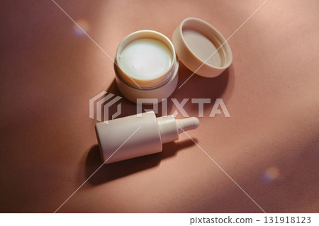 Face cream and serum on a soft beige background. Face cream and serum on a soft beige background. 131918123