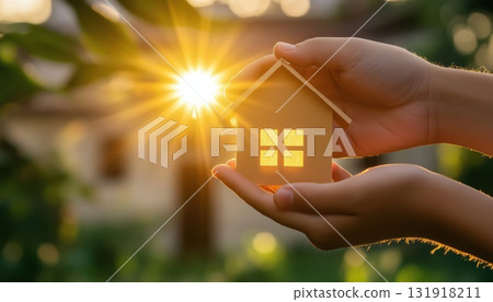 The Family'S Hands Holding A Paper House In The Sun 131918211