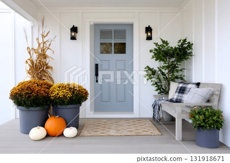 Fall front porch decorating with pumpkins and mums 131918671