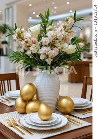 Easter dinner table decorated with golden eggs and flowers 131918714
