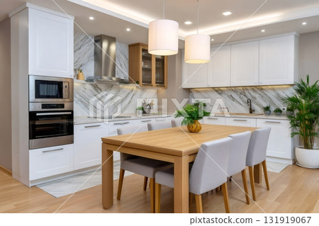 Modern kitchen dining room with white cabinets and marble backsplash 131919067