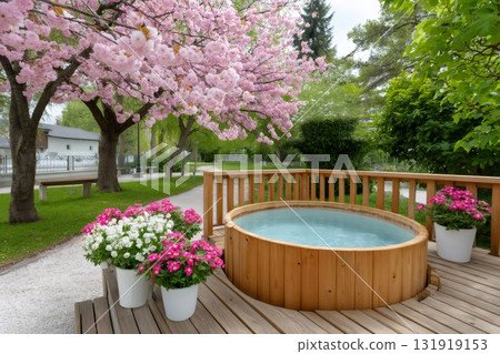 Wooden hot tub on deck with blooming cherry trees 131919153