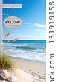 Beautiful sea, sky and sandy beach with Welcome sign, vertical image. 131919158