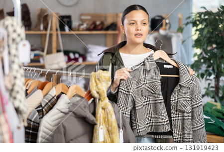 Asian woman browsing goods items and choose elect plaid jacket coat 131919423