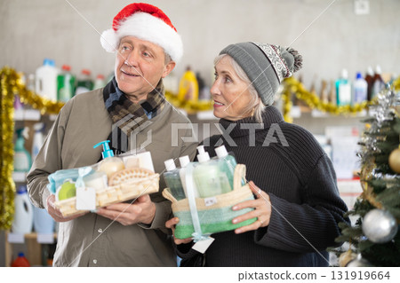 Elderly couple choosing a gift set for Christmas 131919664