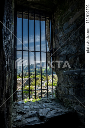 Barred Window In Harlech Castle And View Over Landscape In Gwynedd, North Wales, United Kingdom 131919791