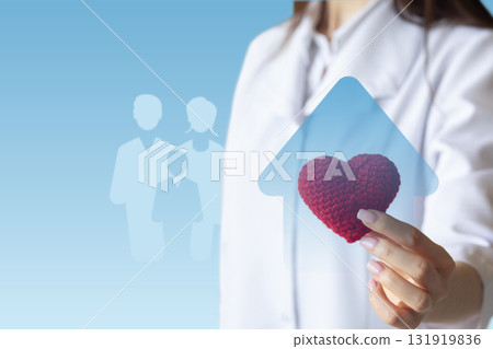 Healthcare professional promotes family wellness with heart symbol. 131919836
