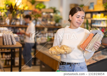 Store visitor, girl in sales area choosing pasta 131919854