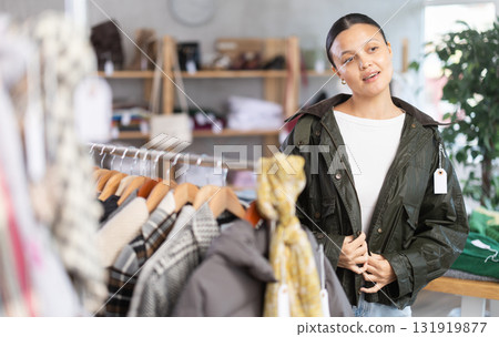 Asian woman try on leather jacket in front of mirror 131919877