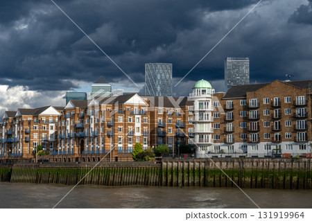 Modern Office Buildings, Skyscrapers And Luxury Apartment Buildings At Canary Wharf Beneath The River Thames In London, United Kingdom Modern Office Buildings, Skyscrapers And Luxury Apartment Buildings At Canary Wharf Beneath The River Thames In London, United Kingdom 131919964
