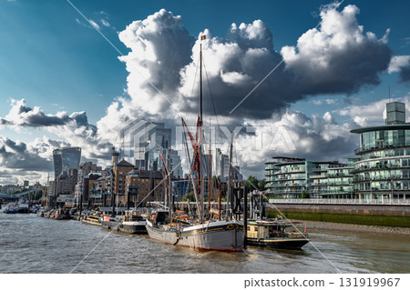 Ships And Boats Anchored On The River Thames In Front Of Modern Office Buildings In The City Of London, United Kingdom 131919967