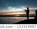 Silhouette Of A Fisherman With His Pole At The Atlantic Coast Of Wales, United Kingdom 131919987