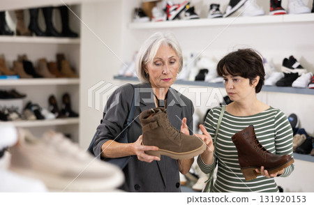Two women are shopping in shoe store 131920153