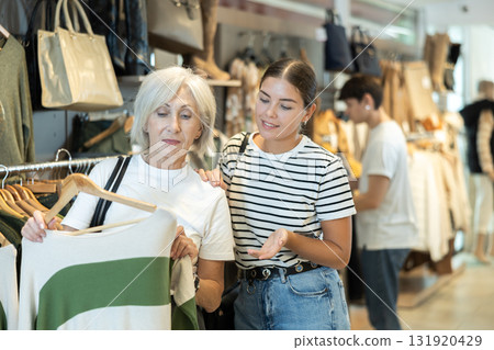 Ladies carefully select sweaters 131920429