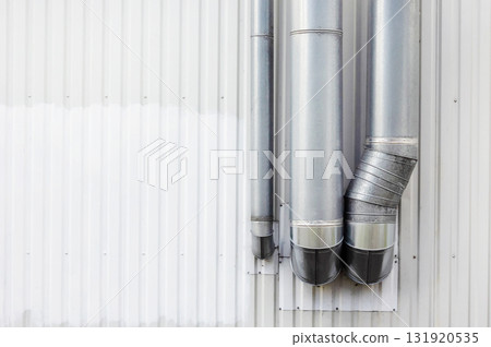 Gray metal fan pipe on buiding wall outside the buidling Gray metal fan pipe on buiding wall outside the buidling 131920535