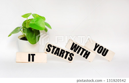 IT STARTS WITH YOU written on wooden blocks on a white background. A place to copy. 131920542