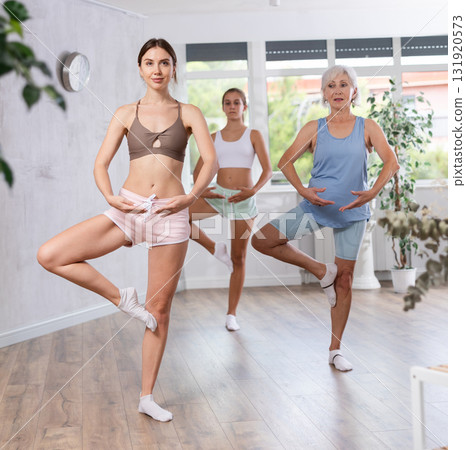 Young woman dancing in group in studio 131920573