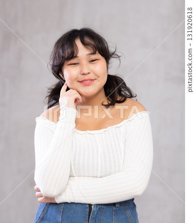 Portrait of smiling young girl posing in studio Portrait of smiling young girl posing in studio 131920618
