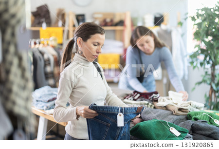 Adult woman choosing jeans in clothing store Adult woman choosing jeans in clothing store 131920865