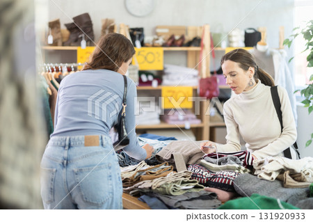 Adult and young woman choosing clothes in store Adult and young woman choosing clothes in store 131920933