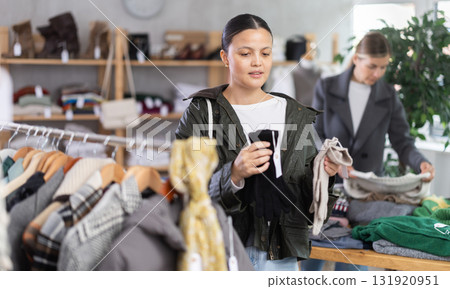 Adult woman choosing gloves in clothing store Adult woman choosing gloves in clothing store 131920951