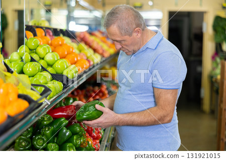 man buy large pepper in supermarket man buy large pepper in supermarket 131921015