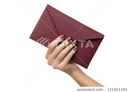 Elegant hand with glossy burgundy nails holding matching burgundy envelope, invitation or wedding concept isolated on transparent background 131921380