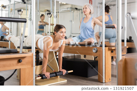 Young girl exercising on wunda chair in pilates studio 131921507