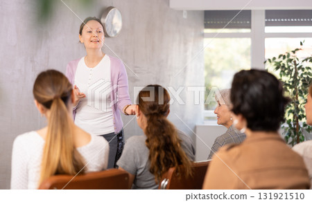 Female coach giving master class to group of women Female coach giving master class to group of women 131921510