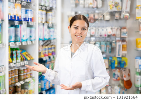 At pharmacy, apothecary waiting for customers and invites with gesture go to department of cosmetics 131921564