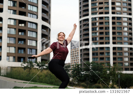 Body positive woman warming up before training. 131921567