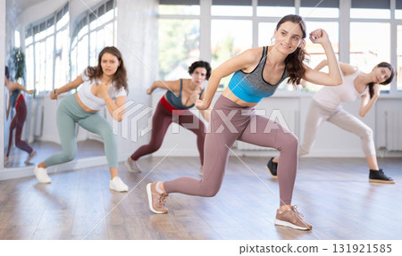 Enthusiastic young girl honing hip-hop moves in dance studio Enthusiastic young girl honing hip-hop moves in dance studio 131921585