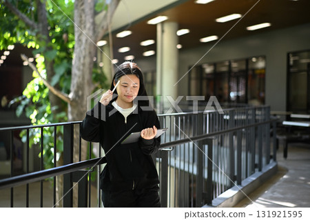 A teenage girl enjoying her creativity through digital art on a tablet 131921595