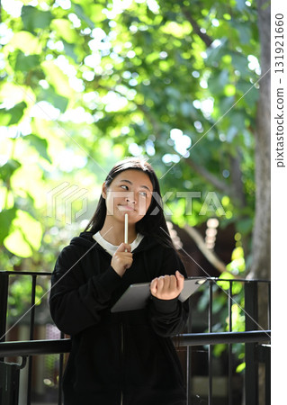 A teenage girl enjoying her creativity through digital art on a tablet 131921660