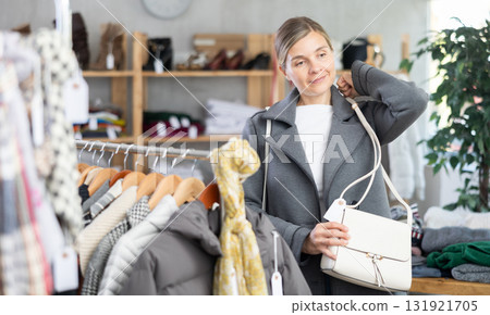 Adult woman choosing handbag in clothing store Adult woman choosing handbag in clothing store 131921705