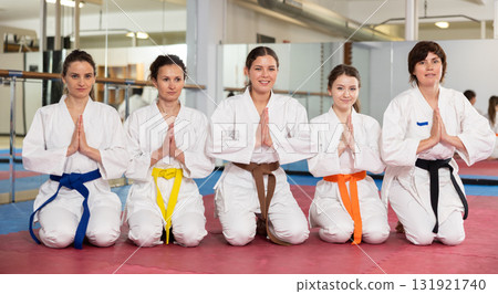 Group of karatekas sitting in pose on floor 131921740