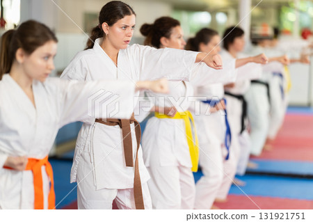 Female athletes standing in formation, kata starting position Female athletes standing in formation, kata starting position 131921751