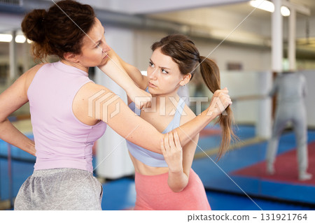 Two women practice self-defense techniques 131921764