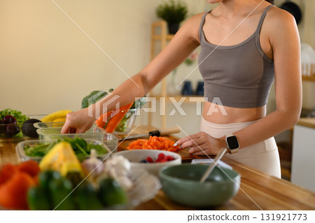 Healthy lifestyle concept with young woman planning and preparing balanced diet meals at home 131921773