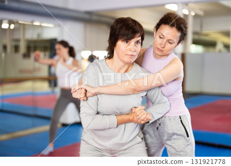Women practice self-defense techniques in pairs Women practice self-defense techniques in pairs 131921778
