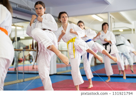 Group of women training karate techniques in studio 131921794