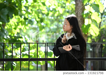 A teenage girl enjoying her creativity through digital art on a tablet 131921798