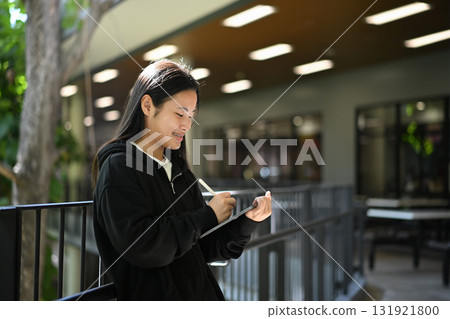 A teenage girl enjoying her creativity through digital art on a tablet 131921800