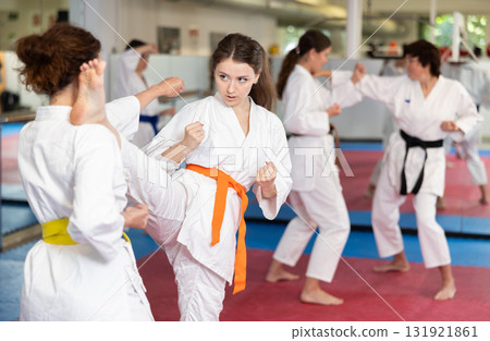 Women pupils train to perform defensive karate installations and attacking combat techniques Women pupils train to perform defensive karate installations and attacking combat techniques 131921861
