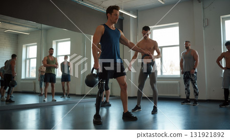 Amputee man with prosthetic leg lifting kettlebell Amputee man with prosthetic leg lifting kettlebell 131921892