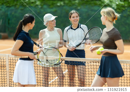 Tennis match female participants chat after game 131921915