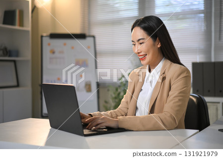 Professional businesswoman using laptop for business tasks or virtual meeting at workplace 131921979