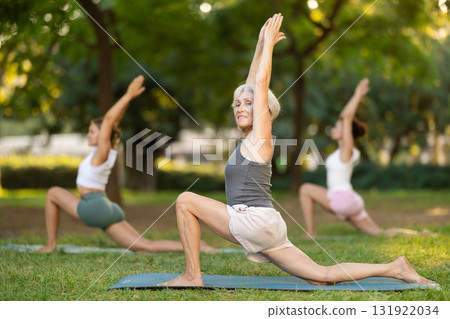 Elderly woman doing yoga in park 131922034