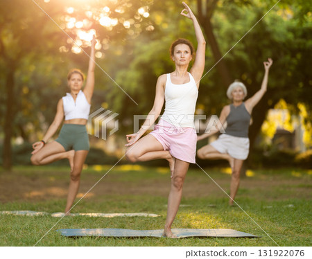 Adult woman doing yoga in park Adult woman doing yoga in park 131922076