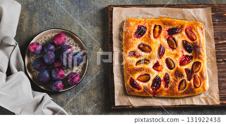 Sweet homemade focaccia with berries on paper on the table top view web banner Sweet homemade focaccia with berries on paper on the table top view web banner 131922438
